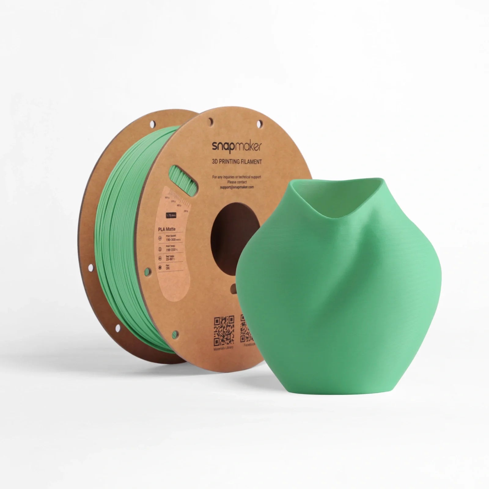 Snapmaker Matte PLA Filament in green beside a smooth-surfaced green printed vase.