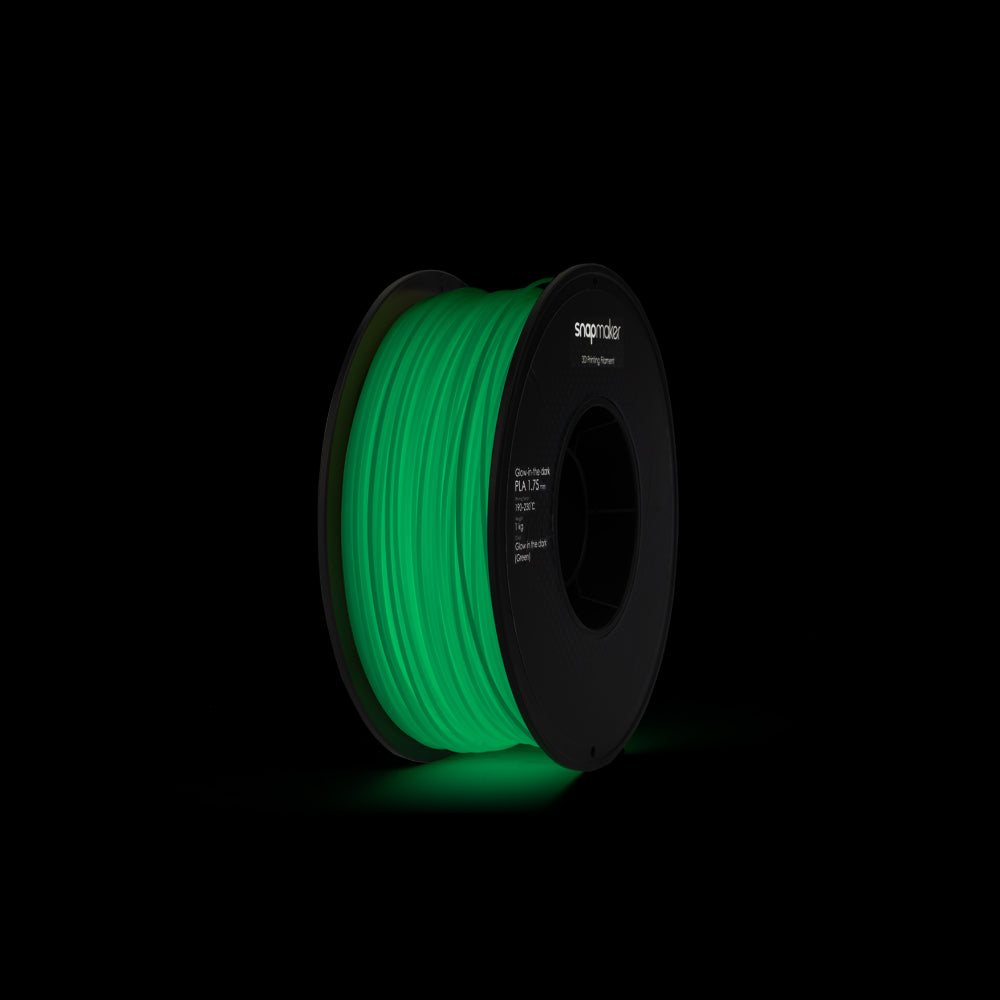 Snapmaker Glow-in-the-dark Green PLA filament spool glowing in the dark.